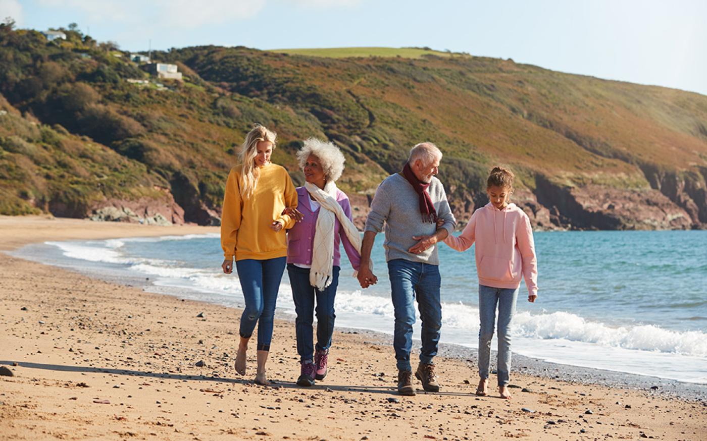 family walking on the beachfront